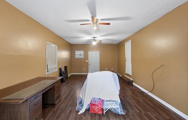 unfurnished bedroom featuring dark hardwood / wood-style floors, ceiling fan, and a textured ceiling