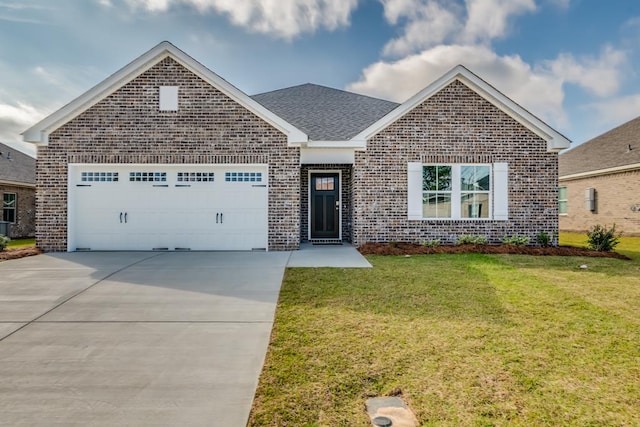 view of front of house with a garage and a front yard