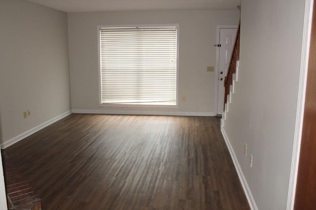 empty room featuring dark hardwood / wood-style flooring