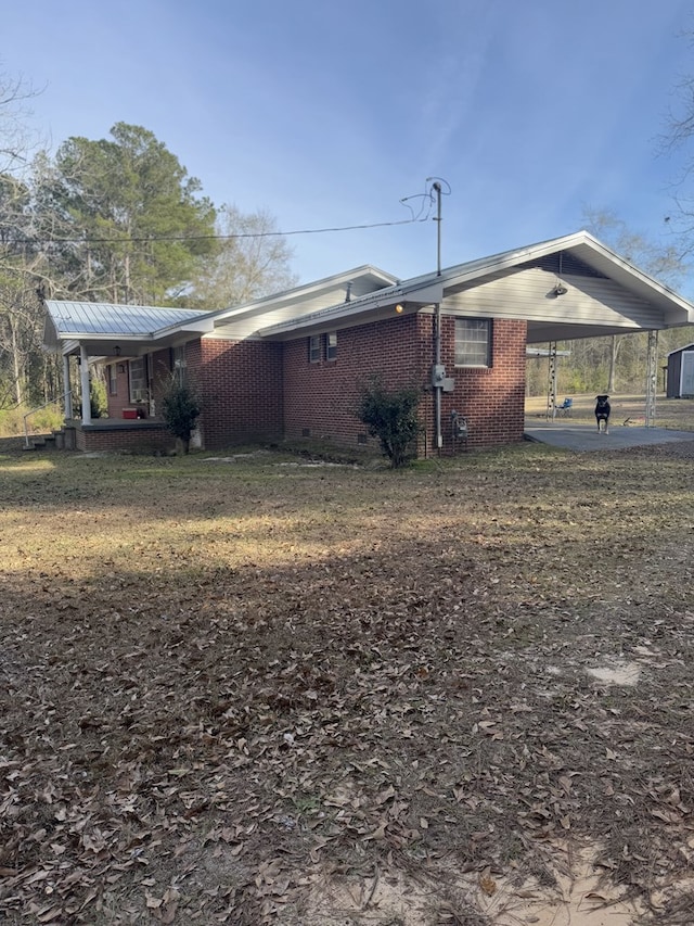 view of side of property with a carport