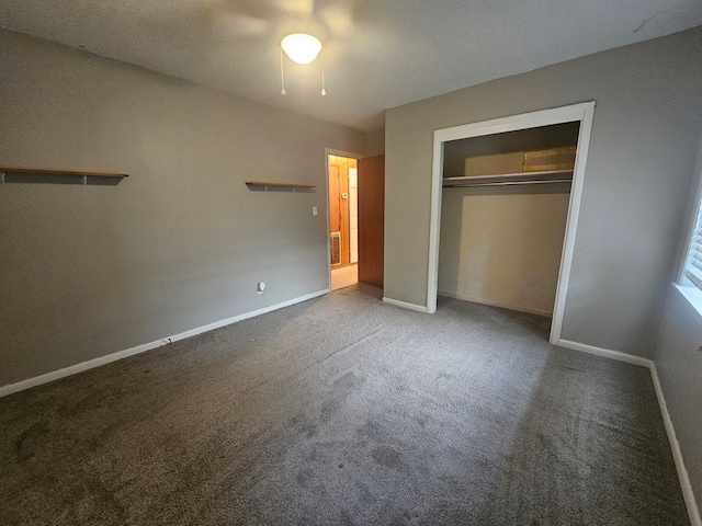 unfurnished bedroom with a closet, carpet flooring, ceiling fan, and baseboards