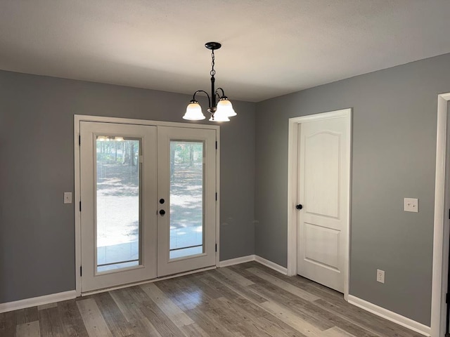 471 Faith St, Enterprise, AL 36330 - entryway with french doors, wood finished floors, and a chandelier