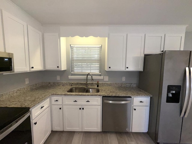 471 Faith St, Enterprise, AL 36330 - kitchen with stainless steel appliances, white cabinets, wood finished floors, and light stone counters