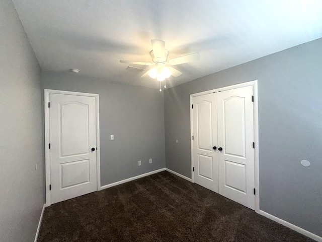 471 Faith St, Enterprise, AL 36330 - unfurnished bedroom with dark colored carpet, a closet, and a ceiling fan