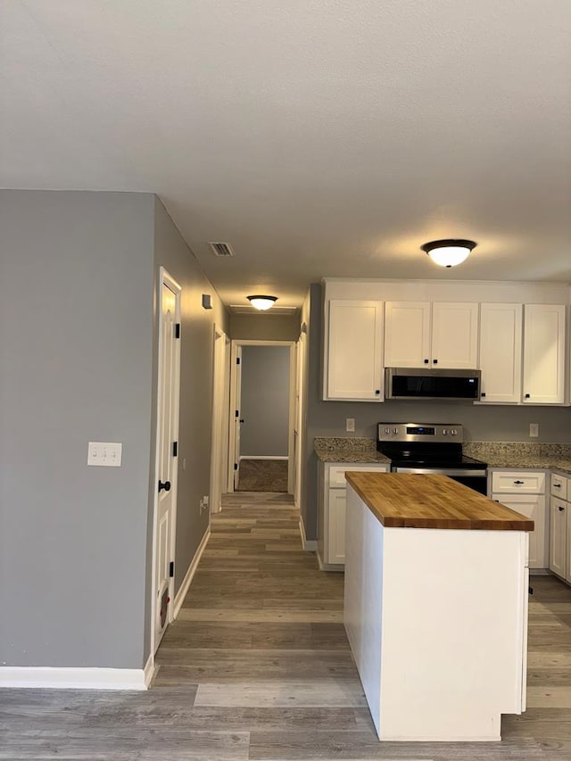 471 Faith St, Enterprise, AL 36330 - kitchen featuring stainless steel appliances, wood counters, white cabinetry, and light wood-style flooring