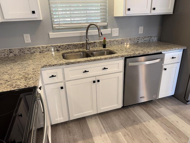 471 Faith St, Enterprise, AL 36330 - kitchen featuring stainless steel appliances, light wood-type flooring, white cabinets, and light stone counters