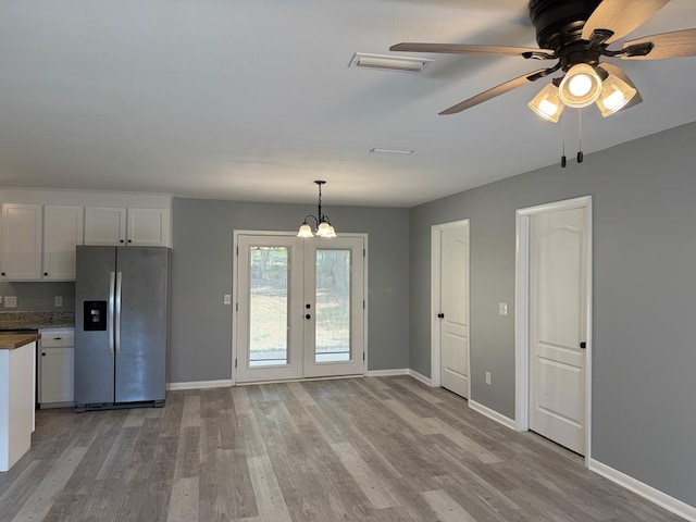 471 Faith St, Enterprise, AL 36330 - kitchen with stainless steel fridge, light wood finished floors, white cabinets, and french doors