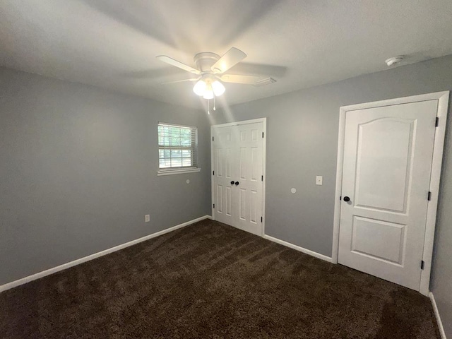 471 Faith St, Enterprise, AL 36330 - unfurnished bedroom with dark carpet, a closet, and ceiling fan