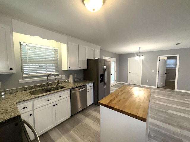 471 Faith St, Enterprise, AL 36330 - kitchen with stainless steel appliances, light wood-type flooring, white cabinets, and butcher block counters