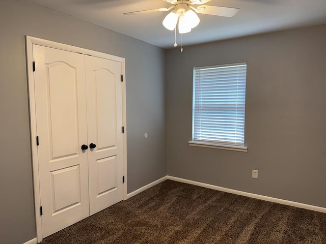 471 Faith St, Enterprise, AL 36330 - unfurnished bedroom featuring dark carpet, a closet, and a ceiling fan