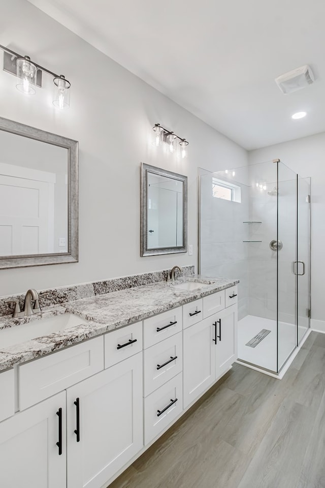 bathroom with vanity, hardwood / wood-style floors, and walk in shower