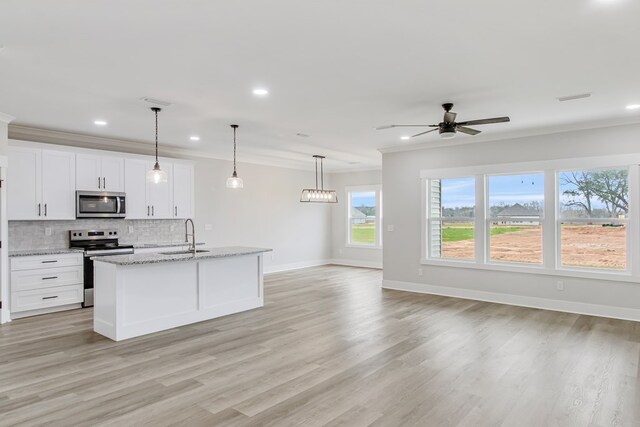 unfurnished living room with ceiling fan, light hardwood / wood-style floors, and ornamental molding