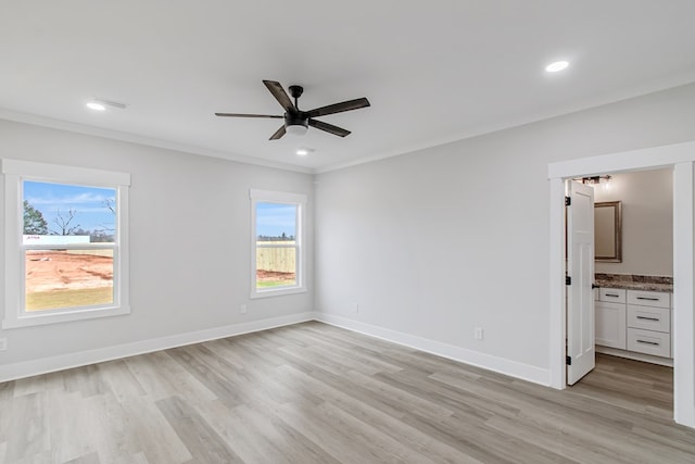 unfurnished bedroom featuring crown molding, ceiling fan, ensuite bathroom, and light hardwood / wood-style floors