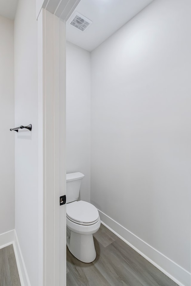 bathroom featuring hardwood / wood-style floors and toilet