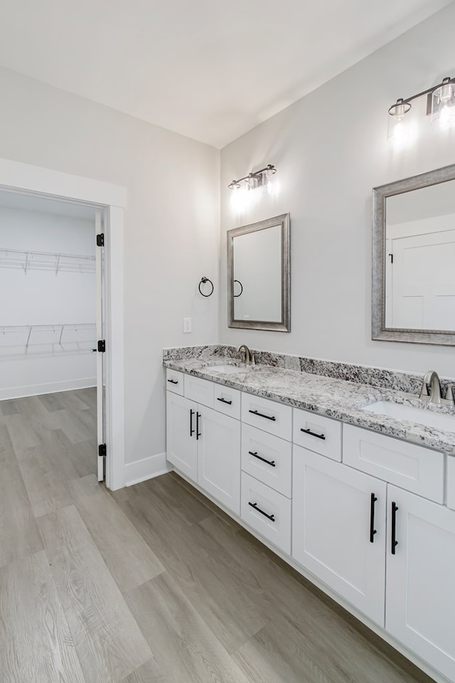 bathroom featuring vanity and hardwood / wood-style floors