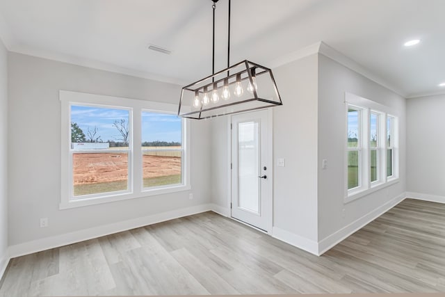 entrance foyer with crown molding and light hardwood / wood-style floors