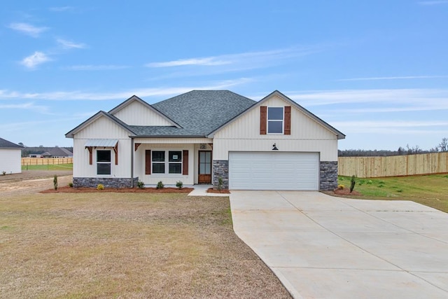 modern inspired farmhouse featuring a garage and a front lawn