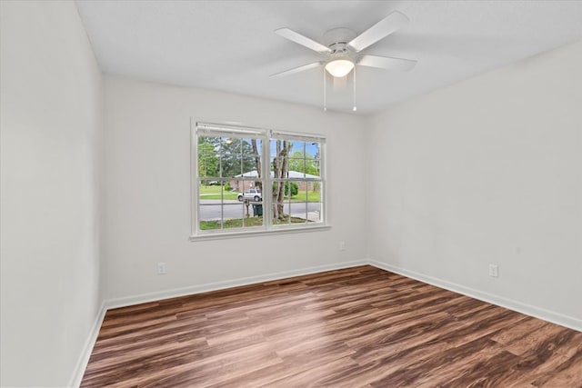 unfurnished room featuring wood finished floors, a ceiling fan, and baseboards