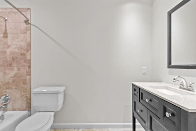 full bathroom with toilet, vanity, shower / bathtub combination, and baseboards
