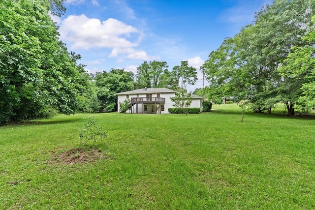 view of green lawn featuring a deck and stairway