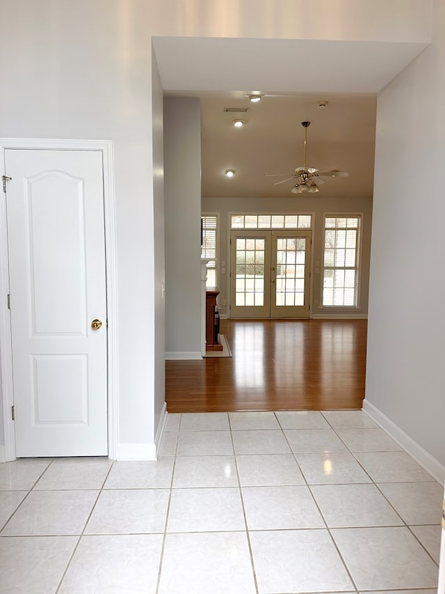 unfurnished room with french doors, ceiling fan, baseboards, and light tile patterned floors