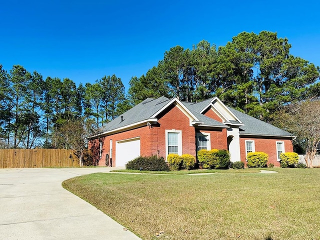 view of front of house with a garage and a front yard