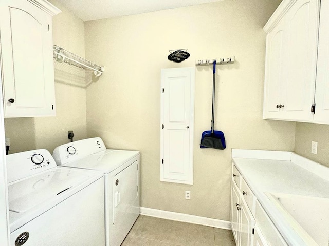 laundry room featuring cabinets, light tile patterned floors, separate washer and dryer, and sink