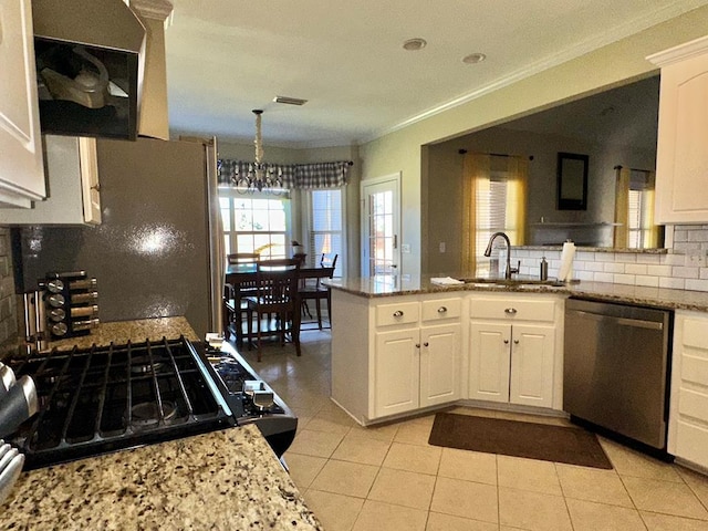 kitchen with white cabinetry, sink, hanging light fixtures, kitchen peninsula, and appliances with stainless steel finishes