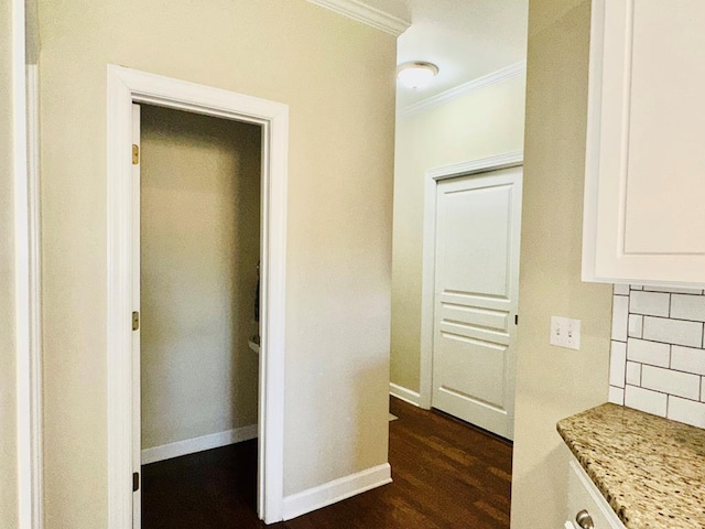 hall with dark hardwood / wood-style flooring and ornamental molding