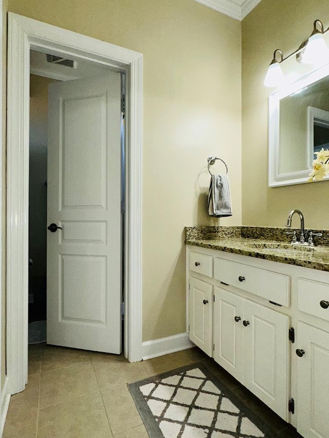 bathroom with tile patterned flooring, vanity, and ornamental molding