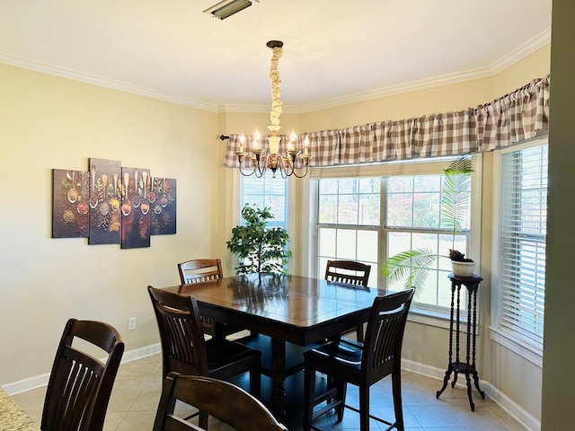 dining room with a chandelier, light tile patterned floors, and ornamental molding