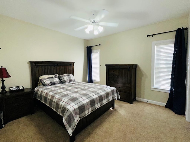 bedroom with ceiling fan and light carpet