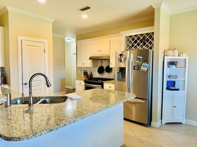 kitchen with light stone countertops, stainless steel appliances, sink, light tile patterned floors, and white cabinets