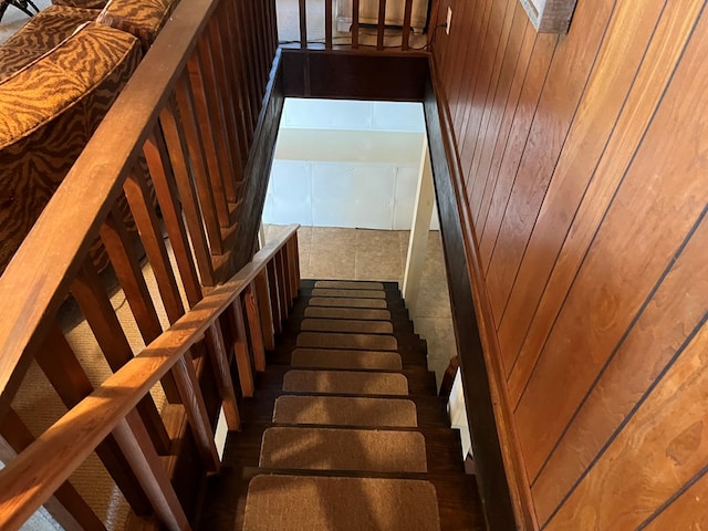 staircase with wood walls