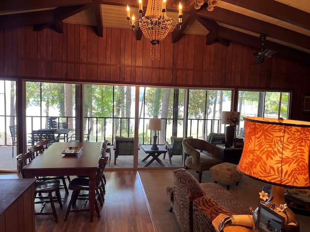 sunroom featuring vaulted ceiling with beams, a notable chandelier, and wooden ceiling