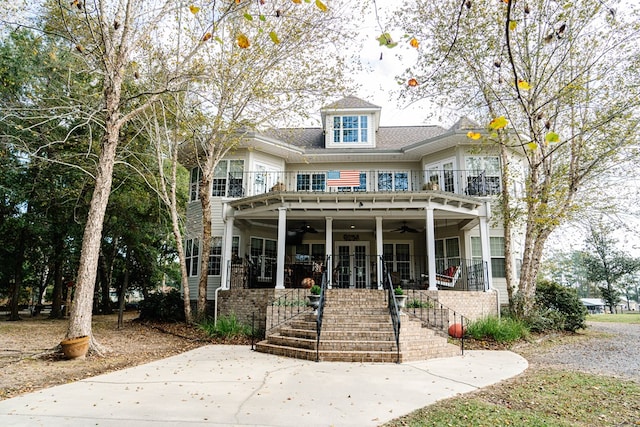 view of front of property featuring ceiling fan, a porch, and french doors