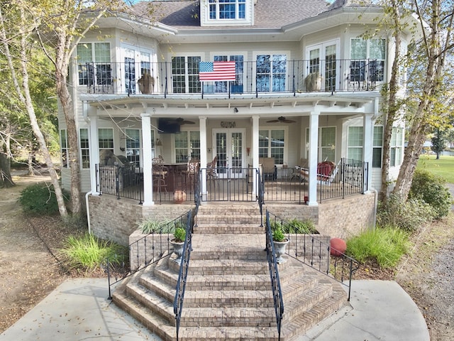 view of front of property with a patio area, ceiling fan, french doors, and a balcony