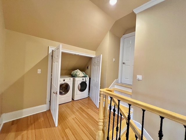 laundry room with washer and clothes dryer and hardwood / wood-style floors