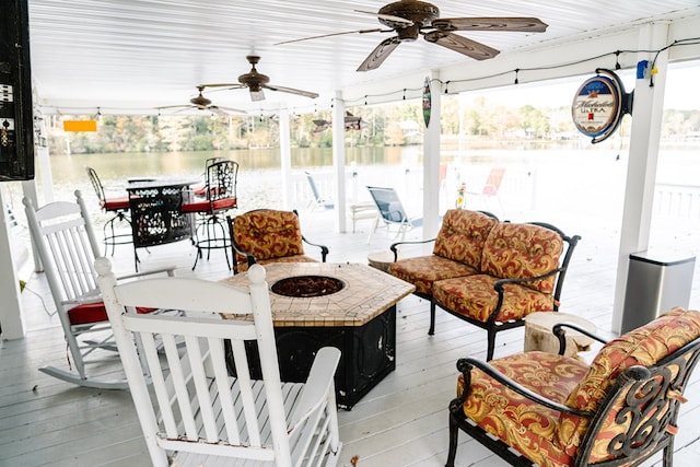 interior space with a water view and an outdoor living space with a fire pit