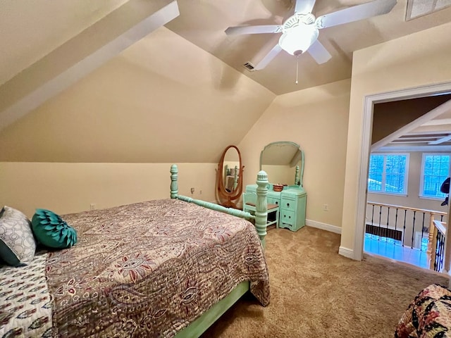 bedroom with light colored carpet, vaulted ceiling, and ceiling fan