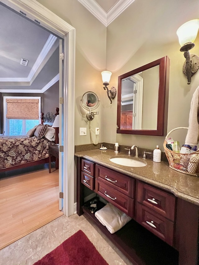 bathroom with vanity, wood-type flooring, and ornamental molding