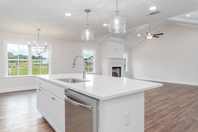 kitchen with plenty of natural light, dishwasher, a center island with sink, and hardwood / wood-style flooring