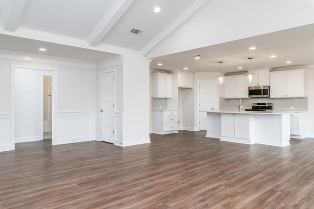 unfurnished living room with lofted ceiling, dark hardwood / wood-style flooring, ornamental molding, and sink