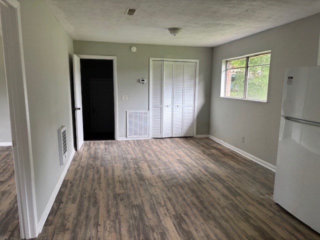 195 Donnie Mae Dr, Dothan, AL 36301 - unfurnished dining area with dark wood-style floors and a textured ceiling