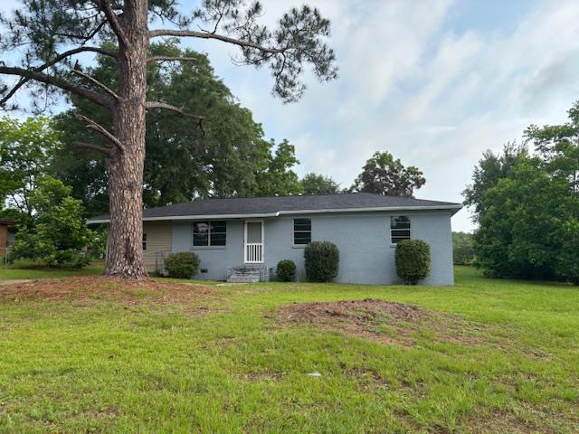 195 Donnie Mae Dr, Dothan, AL 36301 - back of house featuring a lawn and stucco siding