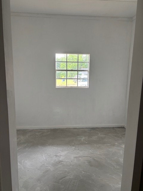 195 Donnie Mae Dr, Dothan, AL 36301 - empty room featuring crown molding and unfinished concrete floors