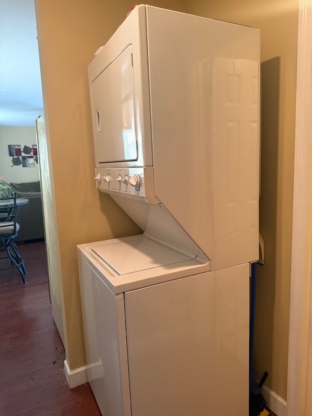 244 Cove Dr, Abbeville, AL 36310 - laundry room with laundry area, baseboards, dark wood-style flooring, and stacked washing maching and dryer