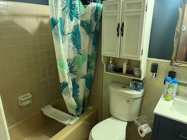 full bathroom featuring shower / bath combo with shower curtain, vanity, tile walls, and toilet