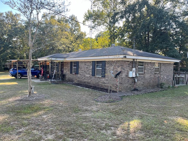 view of property exterior featuring a yard and a carport