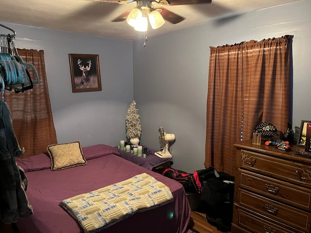 bedroom with ceiling fan and wood-type flooring